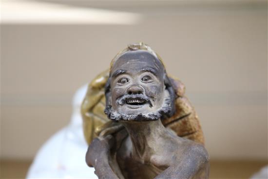 A Shiwan sang-de-boeuf glazed figure of a luohan and an enamelled porcelain figure of a Budai tallest 16cm